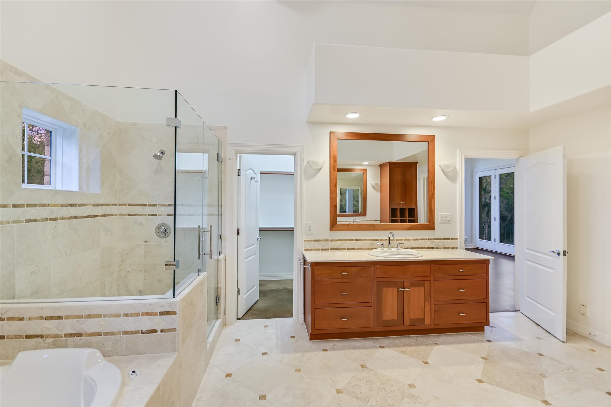 4501 House Of Lancaster Austin, TX 78730 - Photo 21 of 36 a spacious bathroom with a granite countertop sink mirror vanity and toilet