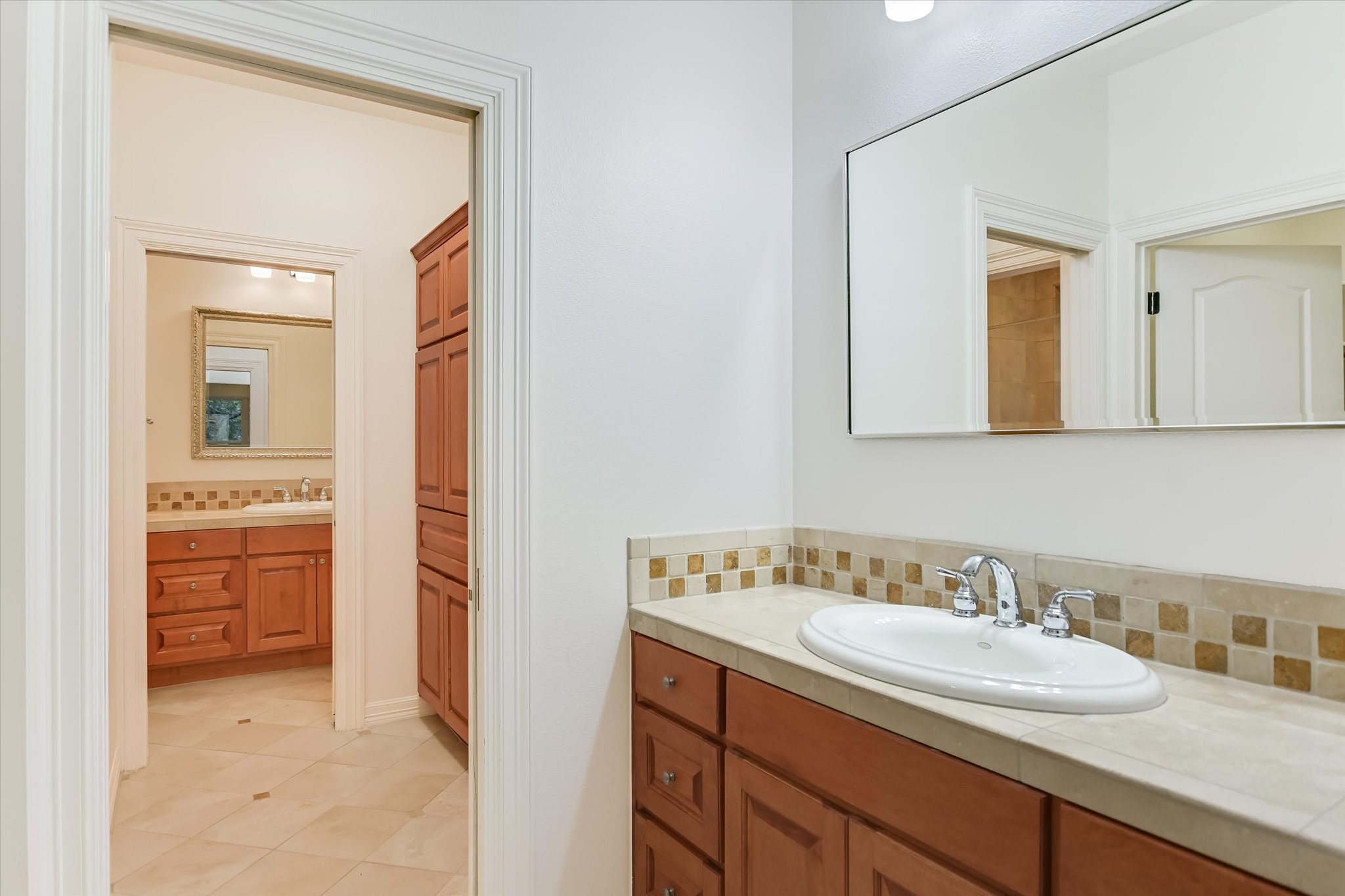 4501 House Of Lancaster Austin, TX 78730 - Photo 25 of 36 a en suite bathroom with a granite countertop sink and a mirror