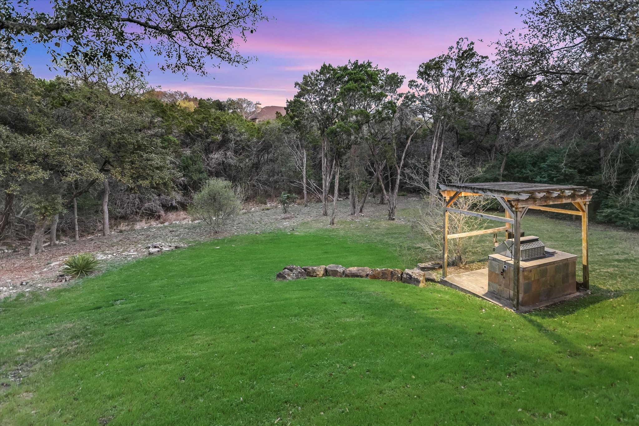 4501 House Of Lancaster Austin, TX 78730 - Photo 29 of 36 a backyard of a house with lots of green space