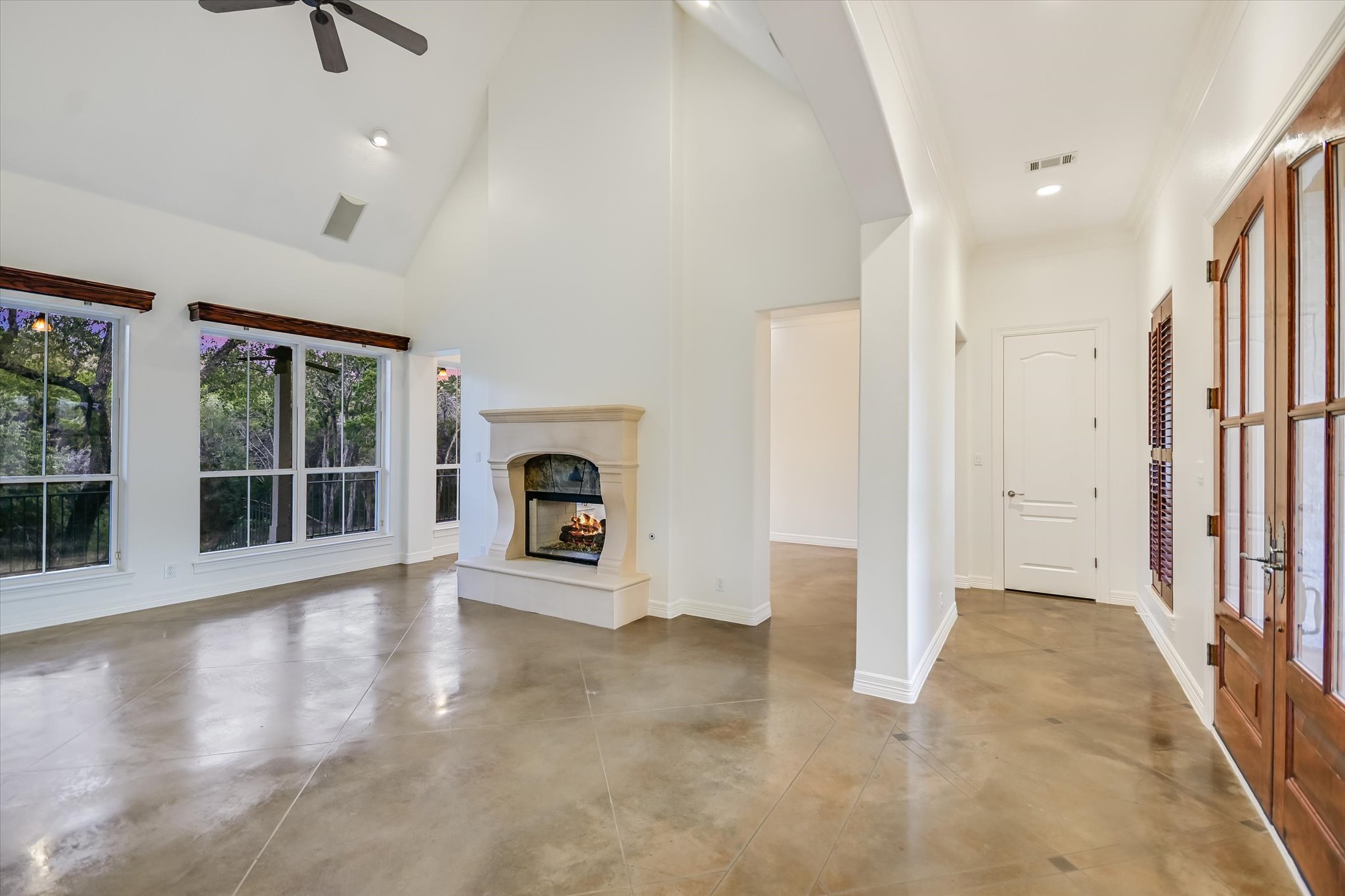 4501 House Of Lancaster Austin, TX 78730 - Photo 4 of 36 an empty room with floor to ceiling windows and fireplace