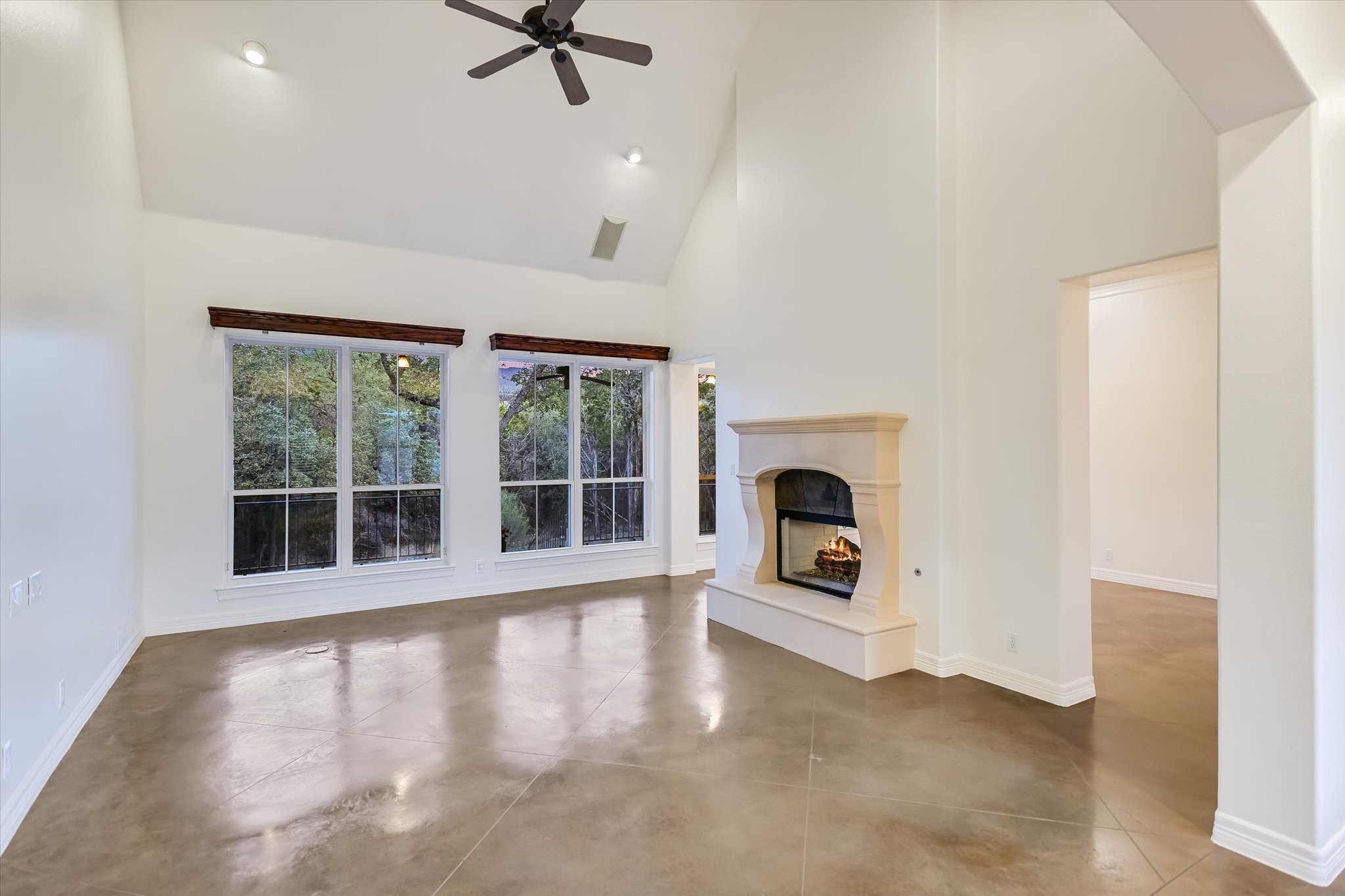 4501 House Of Lancaster Austin, TX 78730 - Photo 6 of 36 an empty room with floor to ceiling windows and fireplace