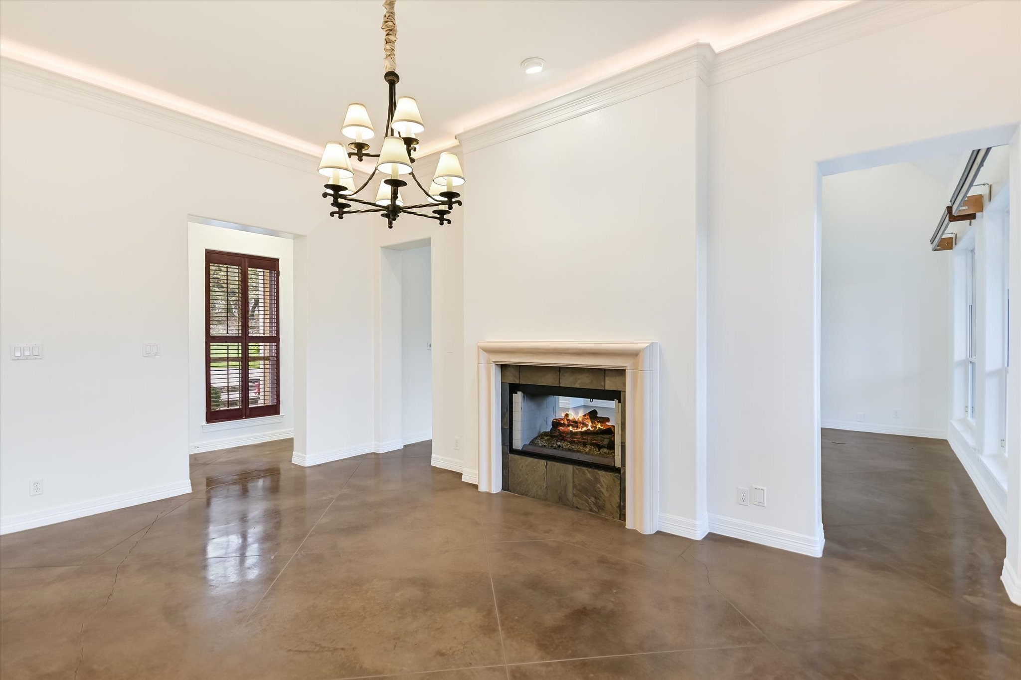 4501 House Of Lancaster Austin, TX 78730 - Photo 9 of 36 a view of a livingroom with a chandelier fan and a fireplace