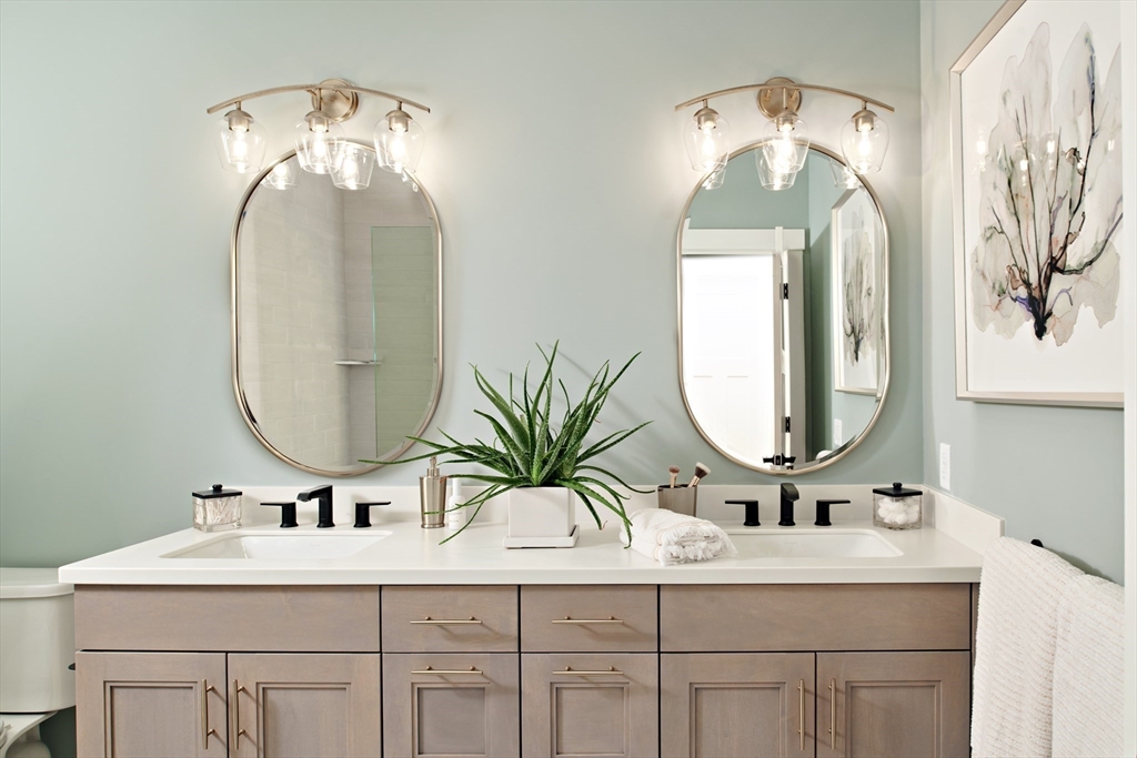 27 Firefly Point, Unit 27 Sudbury, MA 01776 - Photo 11 of 13 a bathroom with double vanity sinks and a mirror