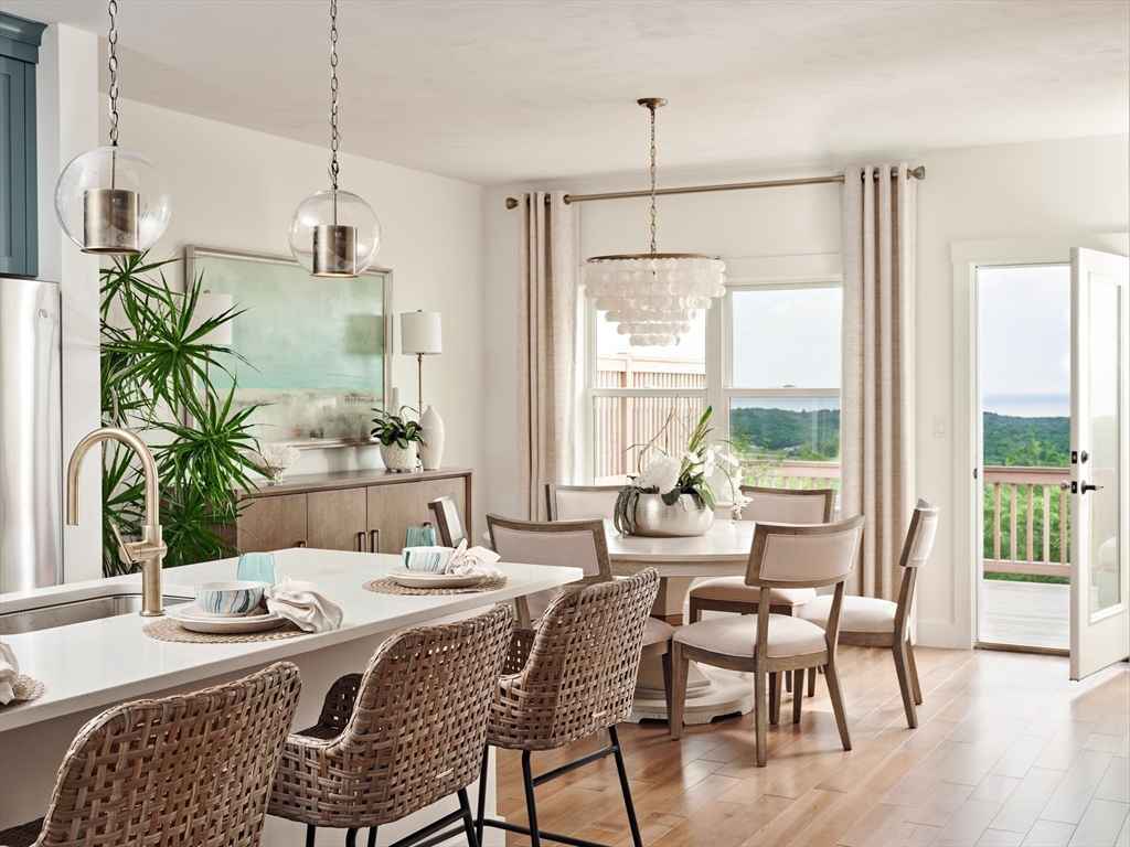 27 Firefly Point, Unit 27 Sudbury, MA 01776 - Photo 5 of 13 a dining room with furniture a chandelier and wooden floor