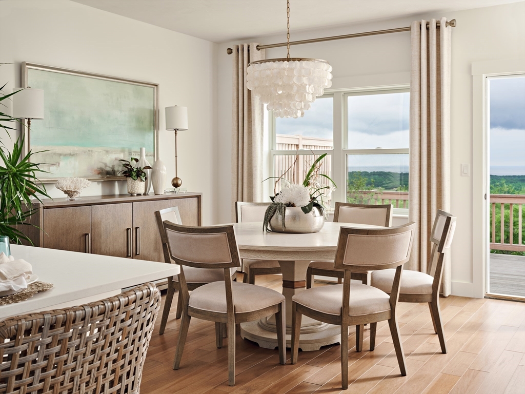 27 Firefly Point, Unit 27 Sudbury, MA 01776 - Photo 6 of 13 a dining room with furniture a chandelier and wooden floor