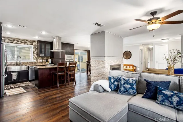 a living room with furniture and kitchen view