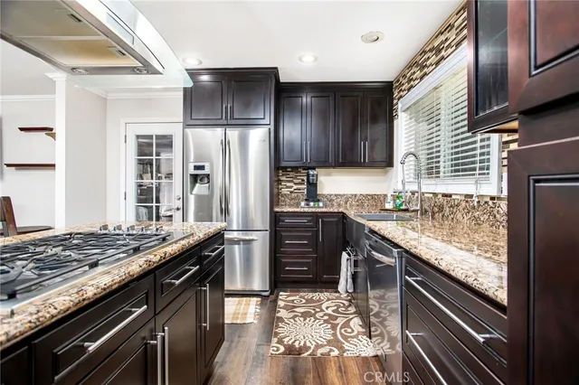 a kitchen with granite countertop stainless steel appliances and wooden cabinets