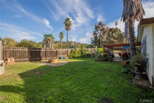 a view of a house with a big yard and potted plants