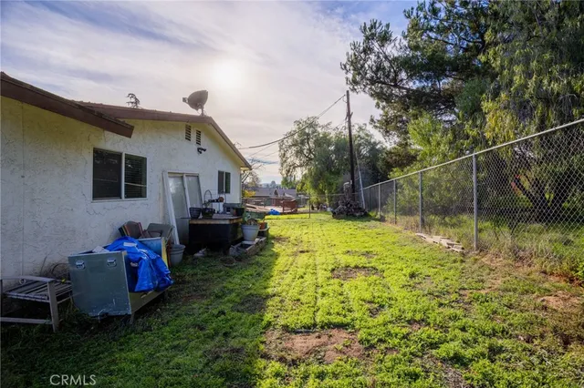 a backyard of a house with yard table and chairs