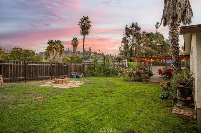 a swimming pool with lots of tress in front of it
