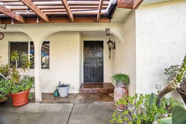 a front view of a house with potted plants