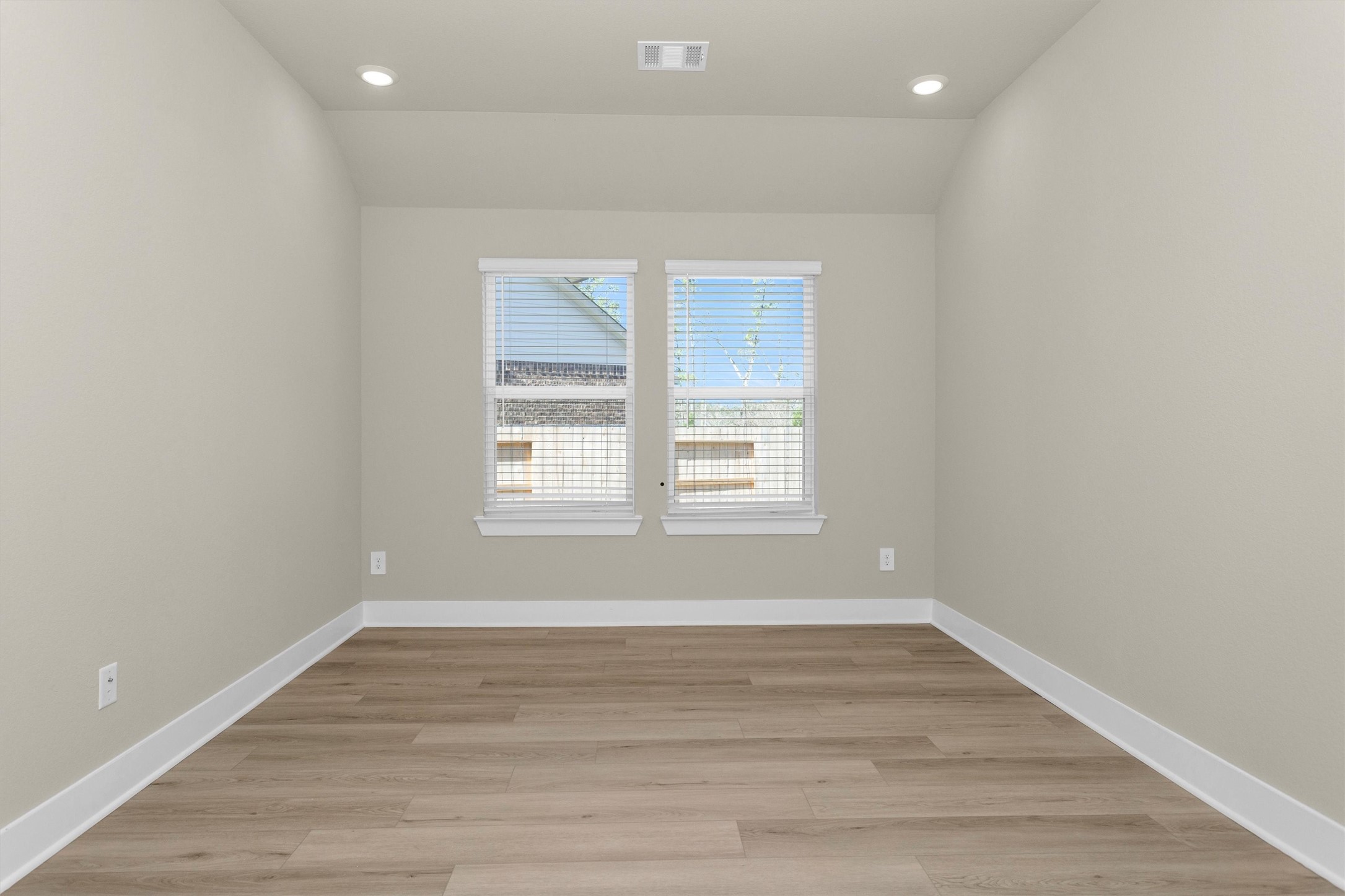 2002 Bluff Oak Street Conroe, TX 77304 - Photo 13 of 30 an empty room with wooden floor and windows