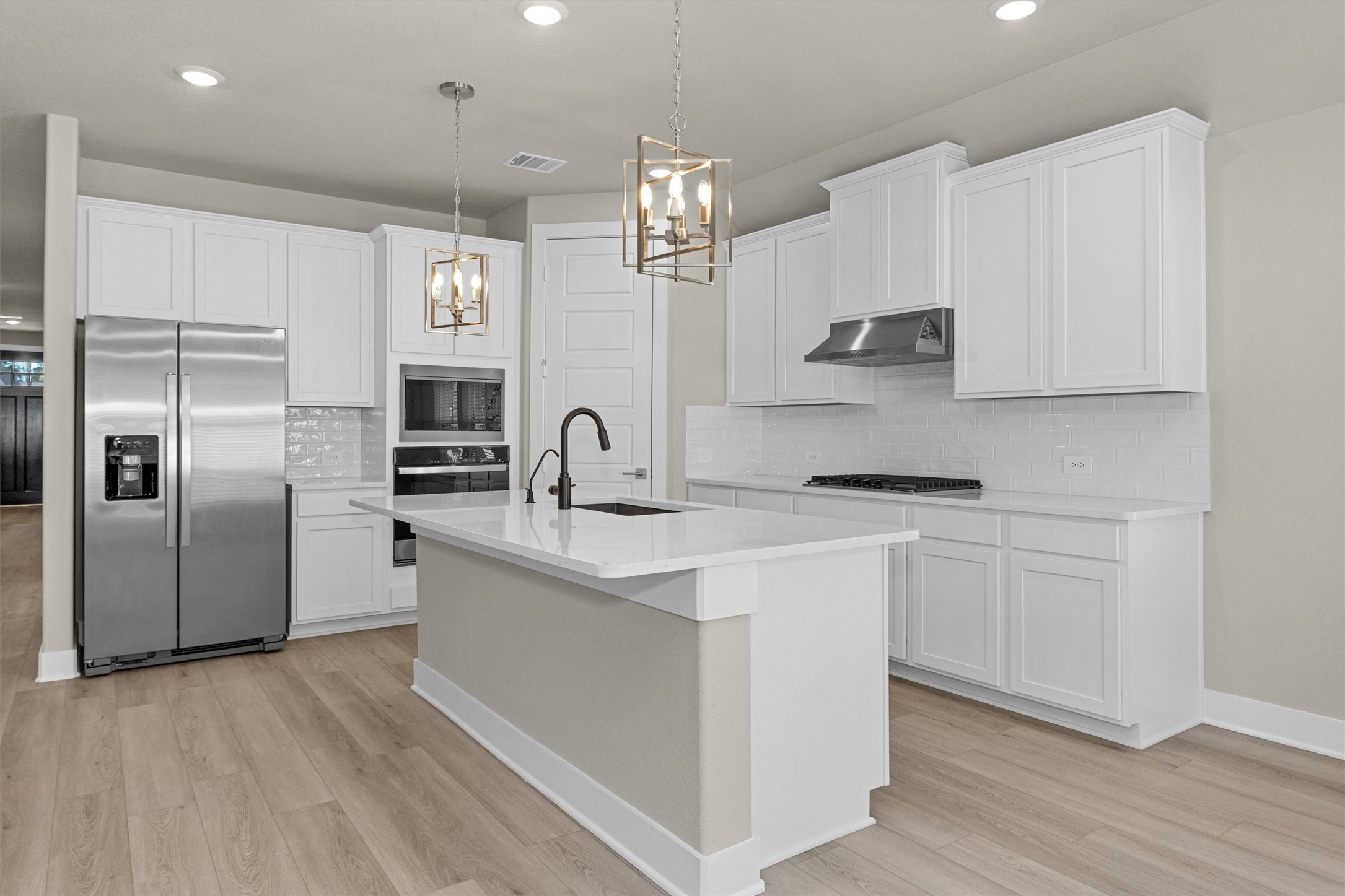 2002 Bluff Oak Street Conroe, TX 77304 - Photo 18 of 30 a kitchen with stainless steel appliances a sink stove and refrigerator