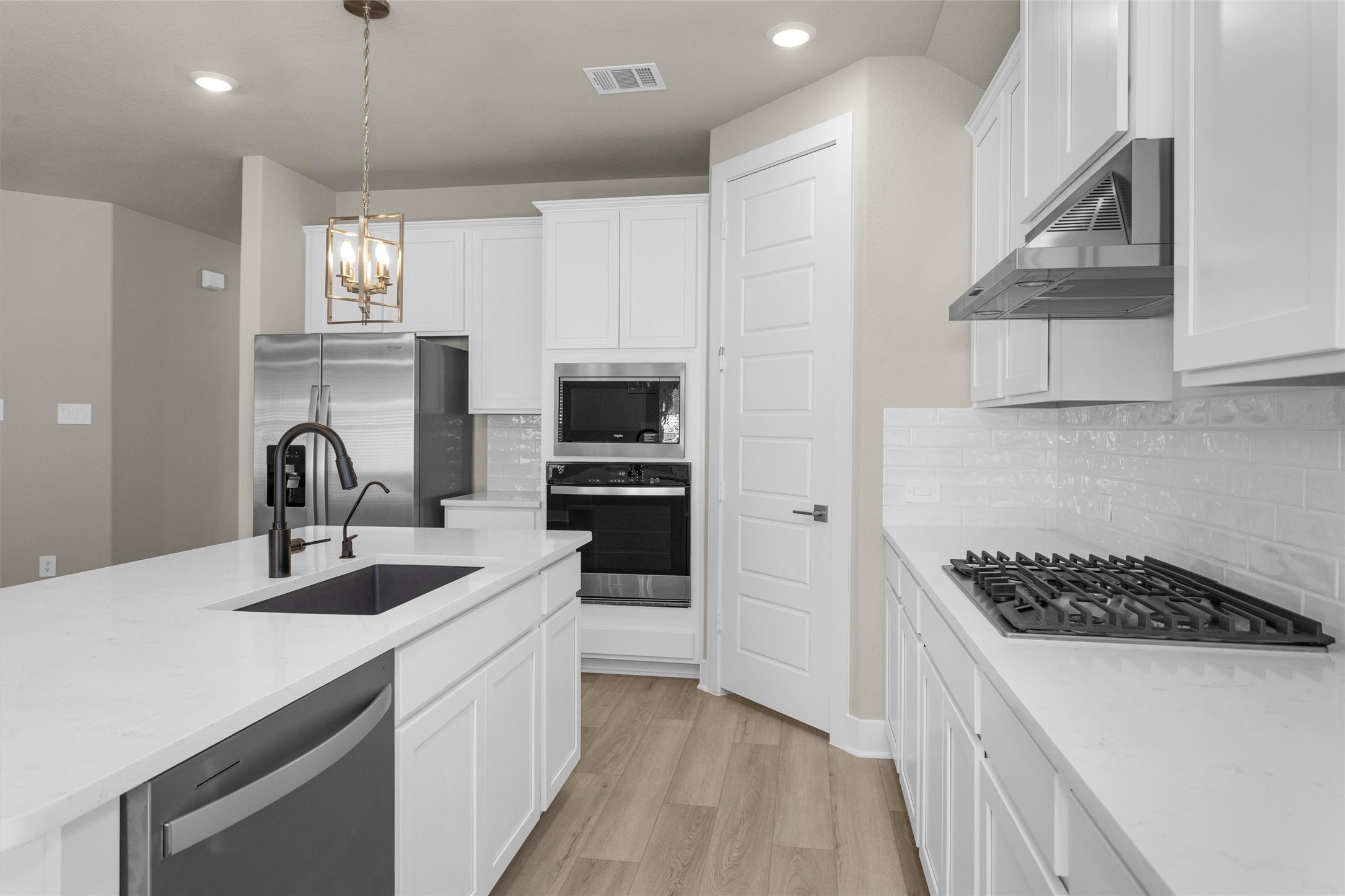 2002 Bluff Oak Street Conroe, TX 77304 - Photo 19 of 30 a kitchen that has a sink and a stove in it