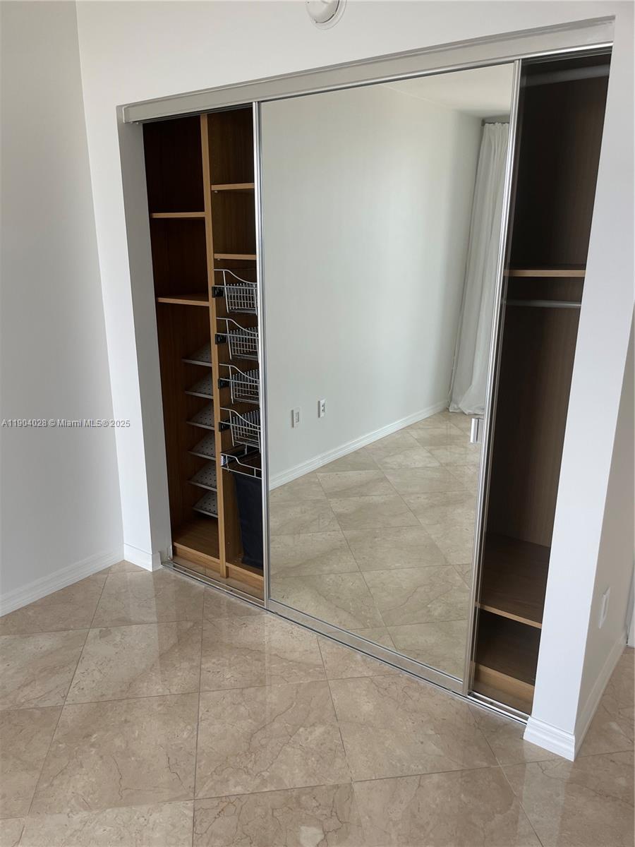 16500 Collins Avenue, Unit 1455 Sunny Isles Beach, FL 33160 - Photo 16 of 35 an empty room with wooden floor and entryway