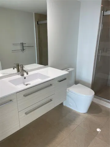 a bathroom with a bathtub sink mirror and toilet