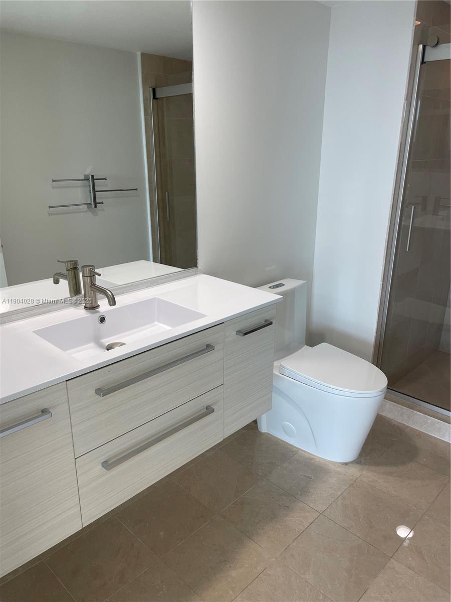 16500 Collins Avenue, Unit 1455 Sunny Isles Beach, FL 33160 - Photo 17 of 35 a bathroom with a sink toilet and vanity