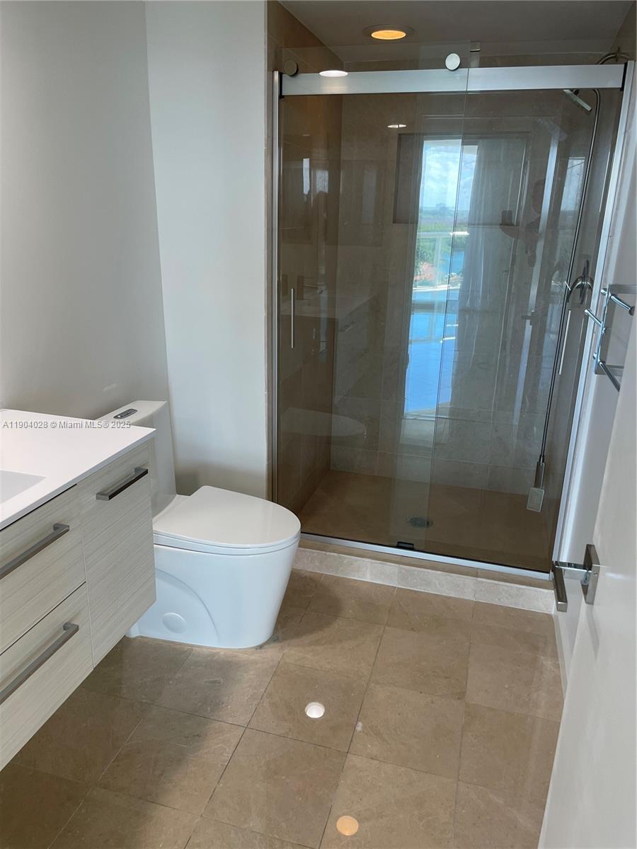 16500 Collins Avenue, Unit 1455 Sunny Isles Beach, FL 33160 - Photo 18 of 35 a bathroom with a shower and toilet