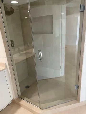 a view of an empty room with a fireplace and a large window