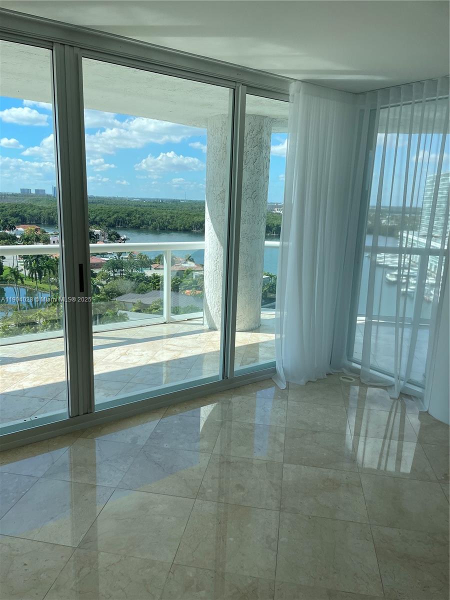 16500 Collins Avenue, Unit 1455 Sunny Isles Beach, FL 33160 - Photo 7 of 35 a view of an empty room with glass door and balcony