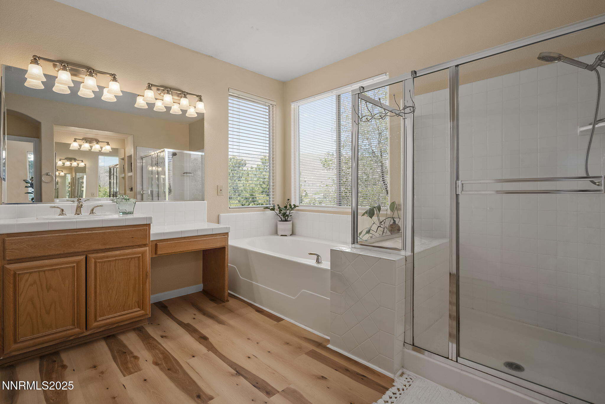 5765 Tappan Drive Reno, NV 89523 - Photo 15 of 27 a large bathroom with a double vanity sink a large mirror and shower