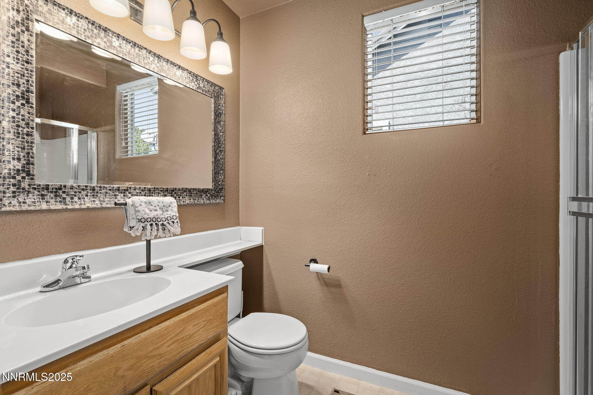 5765 Tappan Drive Reno, NV 89523 - Photo 22 of 27 a bathroom with a sink a toilet and mirror