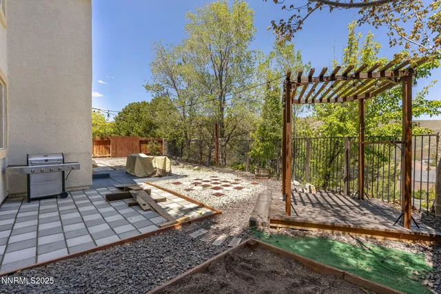a view of a yard with plants and trees