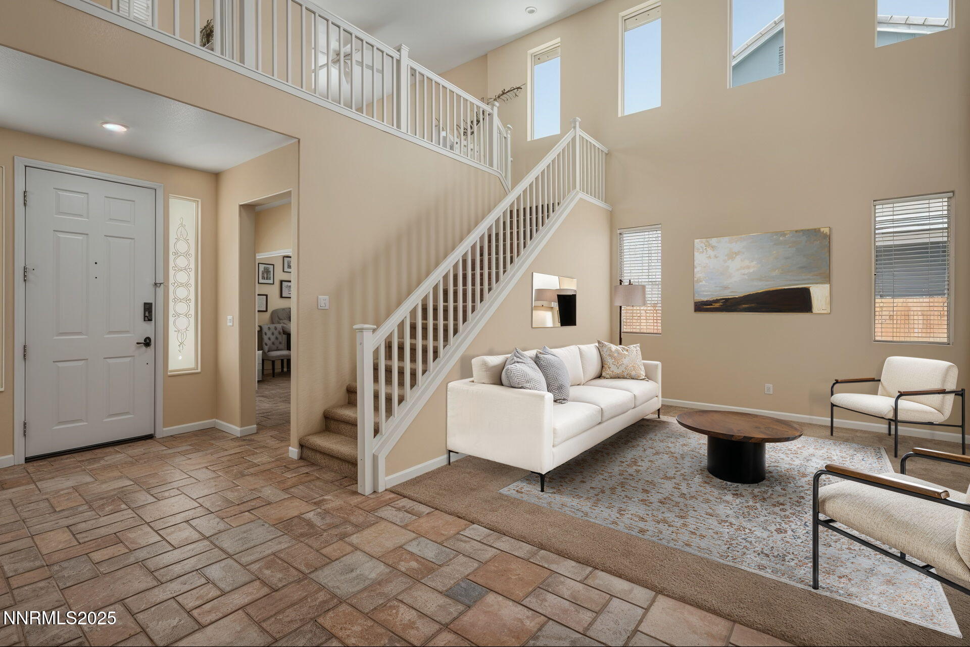5765 Tappan Drive Reno, NV 89523 - Photo 3 of 27 a living room with couches and a dining table with wooden floor