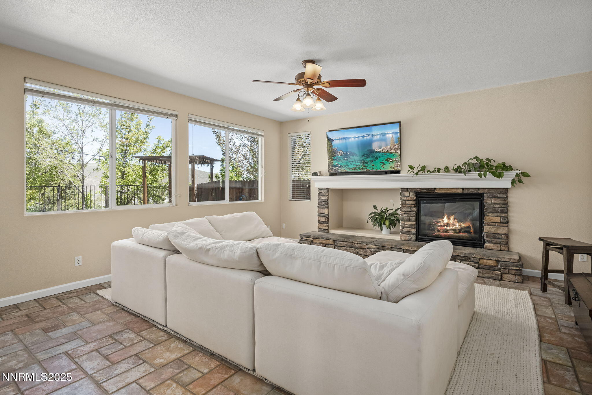 5765 Tappan Drive Reno, NV 89523 - Photo 7 of 27 a living room with furniture a fireplace and a large window