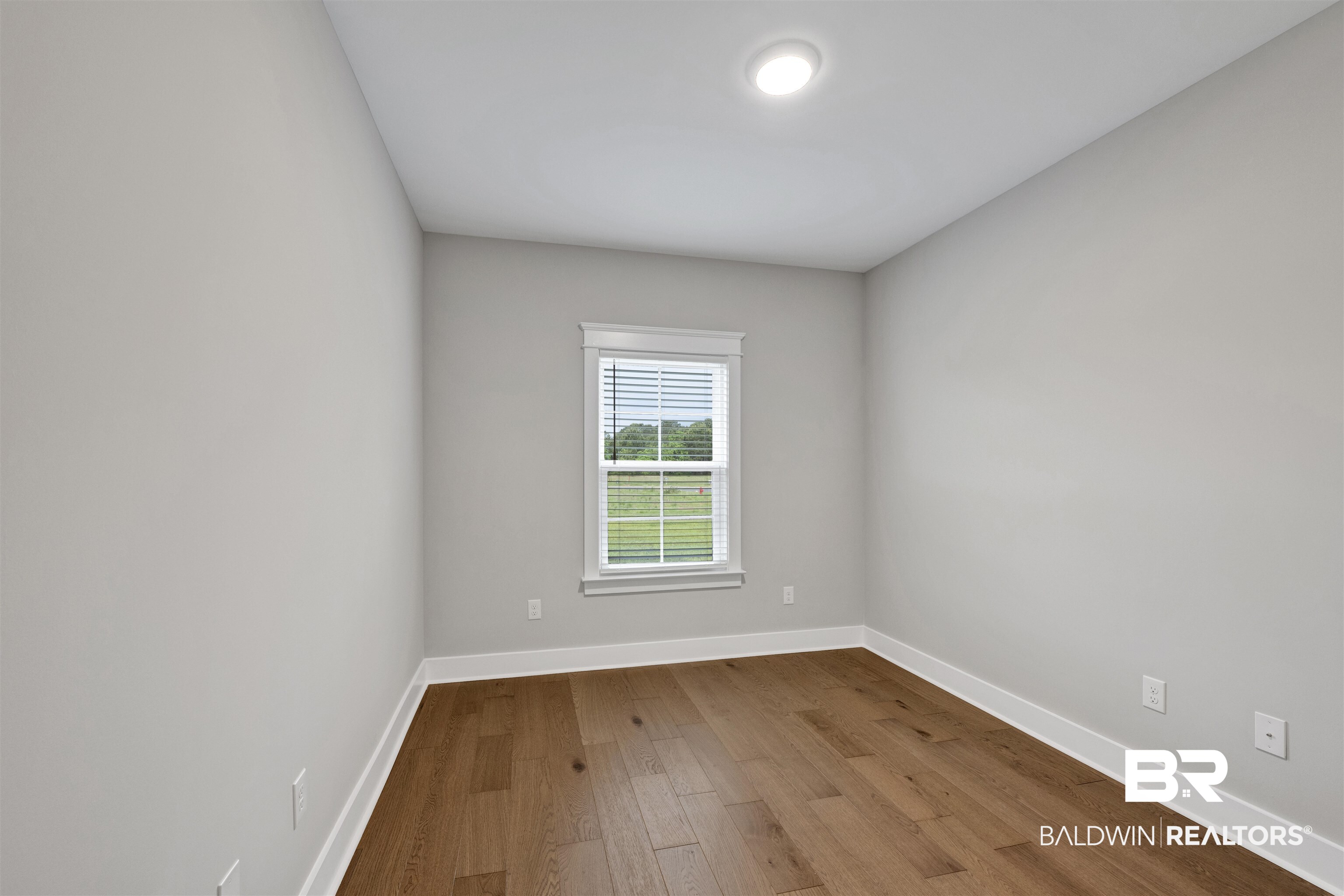 27371 Patch Pl Loop Daphne, AL 36526 - Photo 60 of 63 Neutral gray walls with white trim and wood-finish flooring