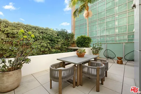 a view of a chairs and table in the patio