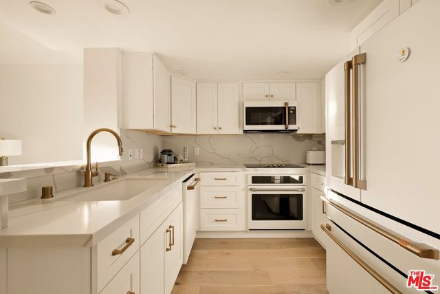 a view of a hallway with washer and dryer