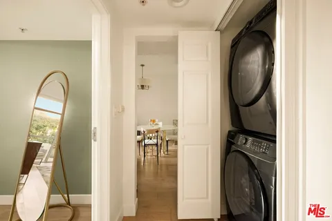 a large bedroom with a bed and flat tv screen on the dresser