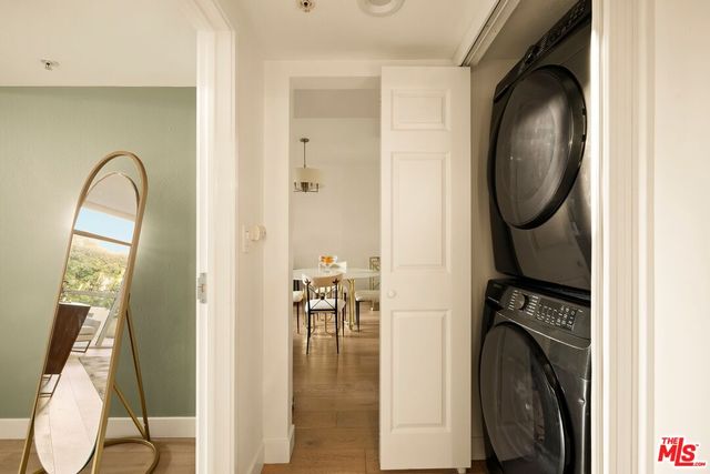 a large bedroom with a bed and flat tv screen on the dresser