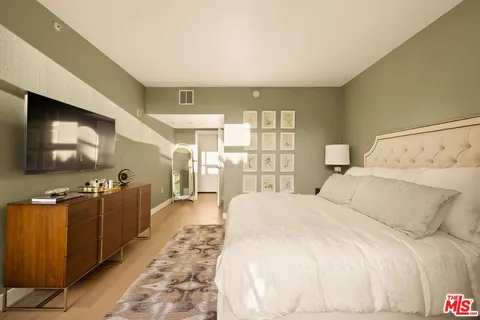 a bedroom with a large bed and a large window