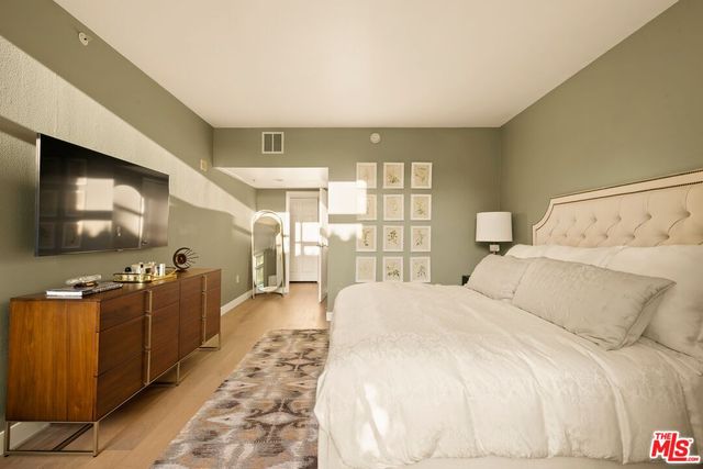 a bedroom with a large bed and a large window