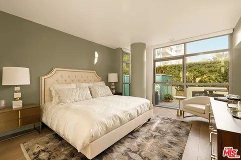 a living room with a large window and furniture