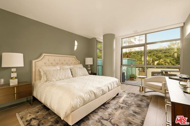 a living room with a large window and furniture