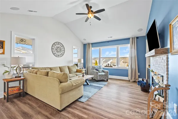 a living room with fireplace furniture and a flat screen tv