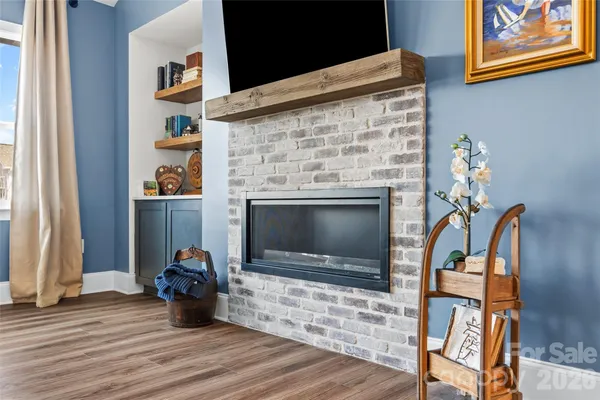 a view of living room with furniture and a fireplace