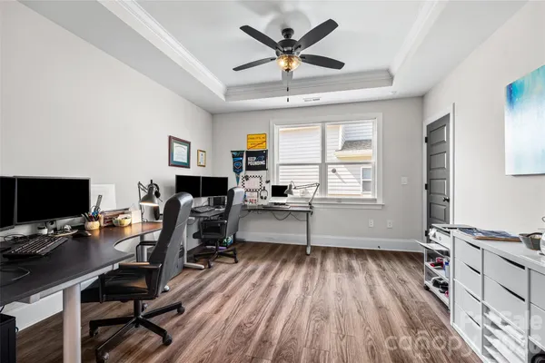 a workspace with wooden floor and a window