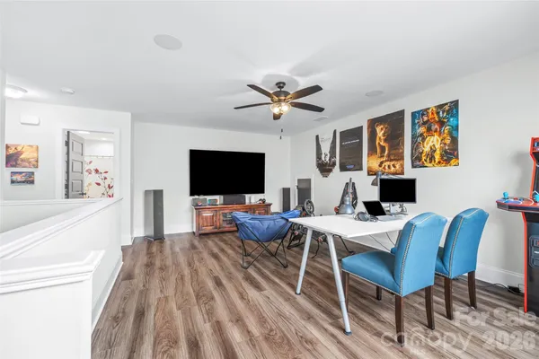 a living room with furniture a flat screen tv and a table