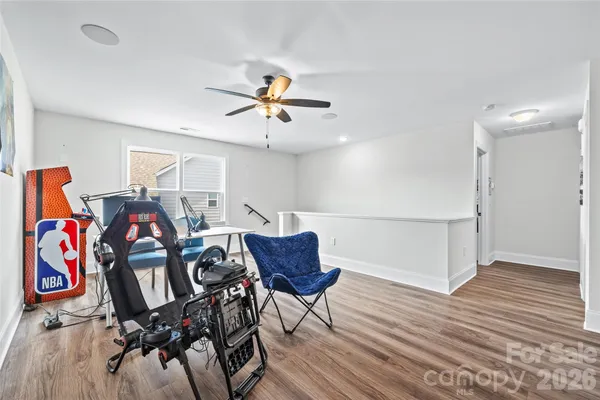 a view of a livingroom with furniture and a ceiling fan