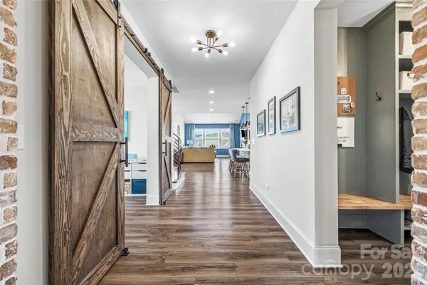 a view of entryway and hall with wooden floor