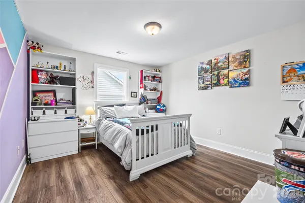 a bedroom with furniture and a window