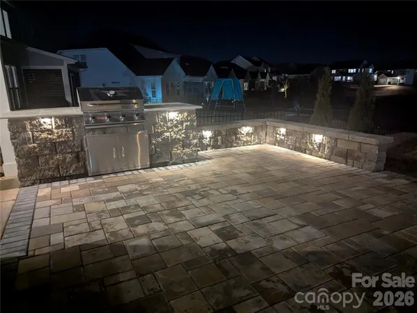 a view of a house with swimming pool and furniture