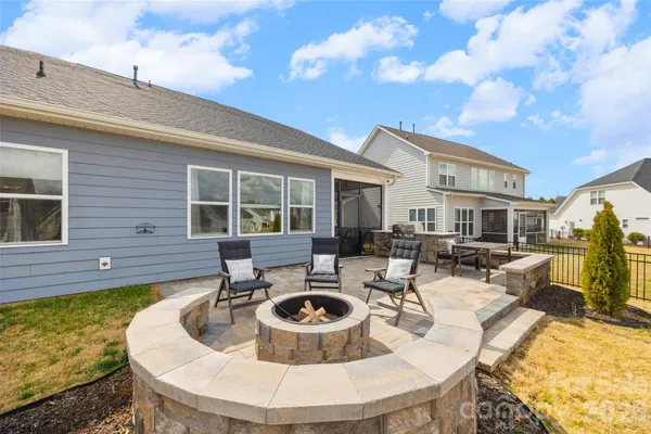 a view of a house with pool and sitting area