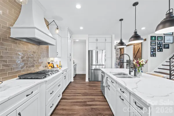 a kitchen with sink a stove and cabinets
