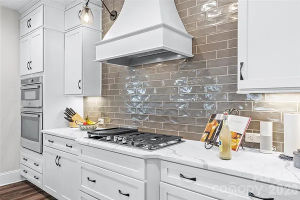 a kitchen with a stove and cabinets