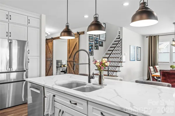 a kitchen with sink and refrigerator